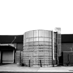 An external stainless steel silo tank, narrating that this option is a designated industrial water pump for liquids in production use.