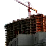 A property development under construction where a crane is found, portraying a specialised development of water pumps for the construction site.